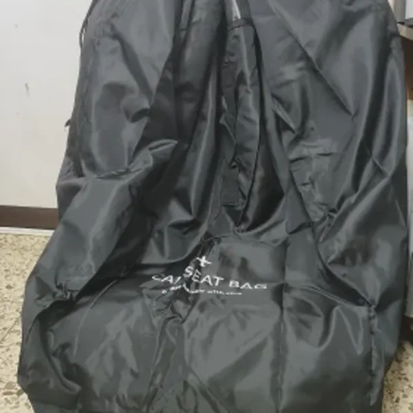 Car seat inside the black SeatPorter travel bag at home